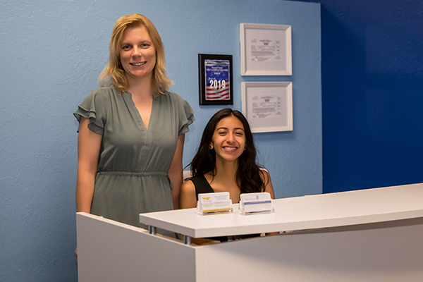 The Consultation Center Staff behind desk The Consultation Center Staff
